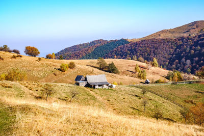 Scenic view of landscape and mountains against clear sky