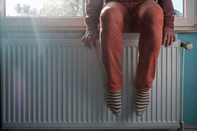 Low section of woman standing on floor at home