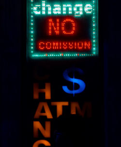 Close-up of illuminated text on bus sign at night