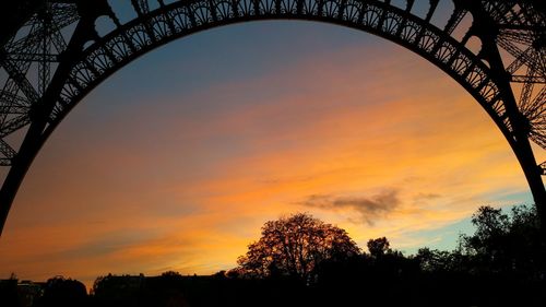 Low angle view of built structure at sunset