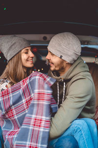 Portrait of a smiling man with woman in car