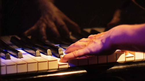 Cropped hands playing piano