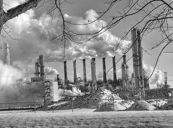 Smoke stack against sky during winter
