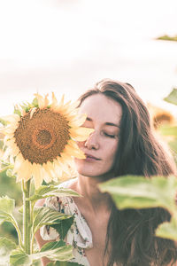 Close-up of smiling woman holding flower