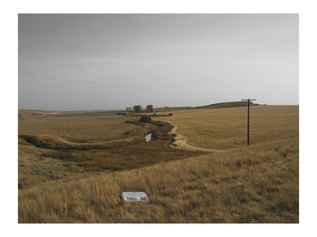 Scenic view of farm against sky