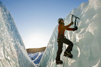 Woman climbing on the fjallsjökull glacier in iceland