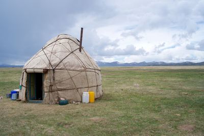 Built structure on field against sky