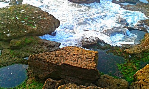 High angle view of stream flowing through rocks