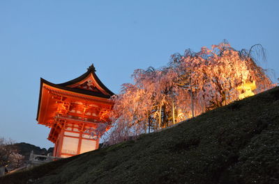 Illuminated traditional building against clear sky