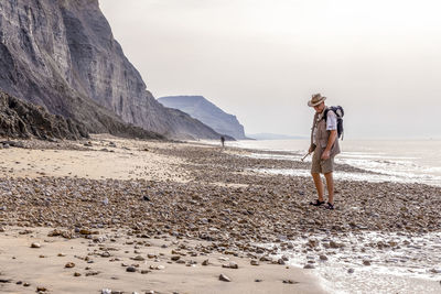 Rear view of woman walking at beach