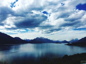 Scenic view of sea and mountains against sky