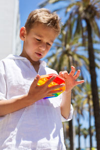 Full length of boy holding baby outdoors