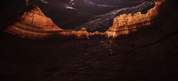 Close-up of rock formation in sea at night