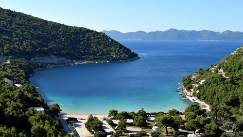 High angle view of sea against clear blue sky