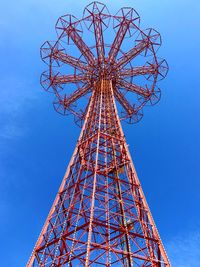 Low angle view of ferris wheel against blue sky