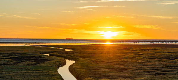 Scenic view of beach against sky during sunset