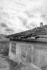 Houses against cloudy sky