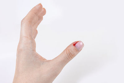 Close-up of woman hand over white background