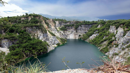 Scenic view of river amidst mountains against sky