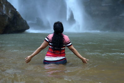 Rear view of woman in sea