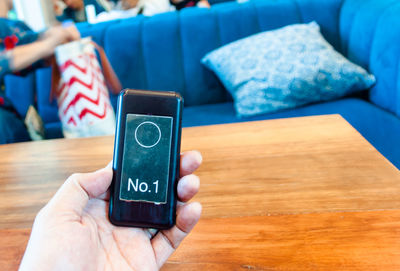 Close-up of person using mobile phone on table