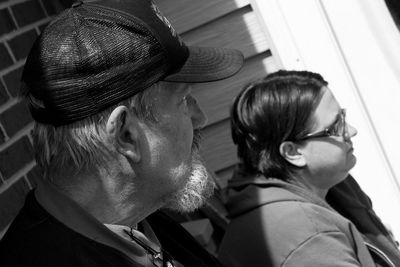 High angle view of father and daughter outside house on sunny day