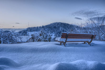 Snow covered landscape against sky