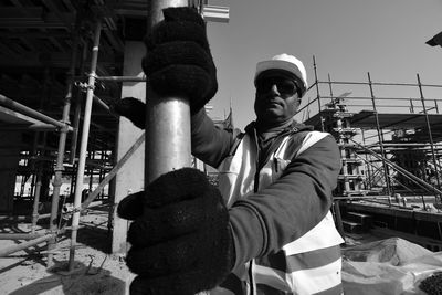 Low angle view of man working at construction site