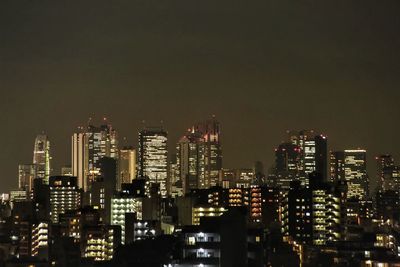 Low angle view of skyscrapers lit up at night