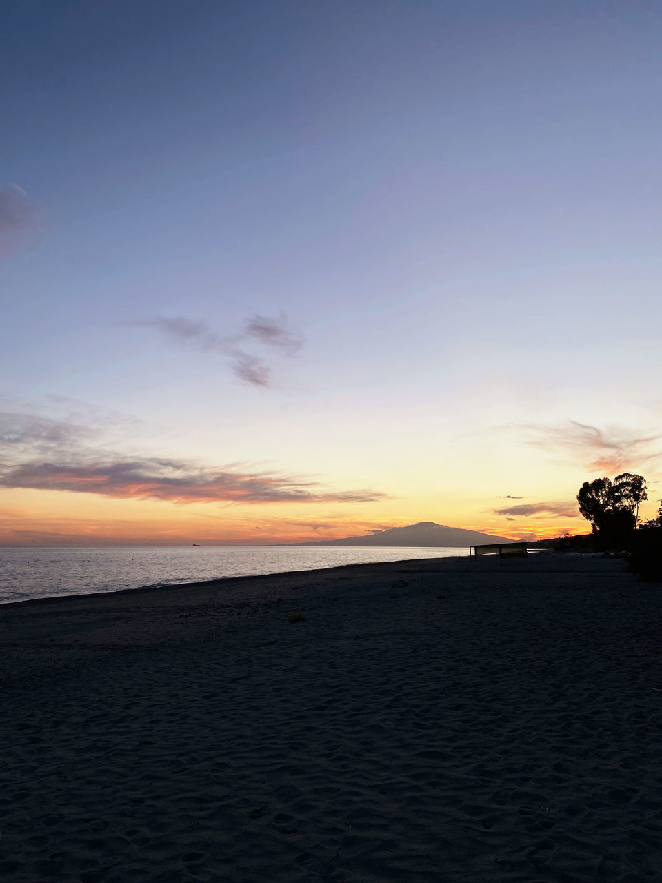 sky, sunset, sea, beauty in nature, land, scenics - nature, beach, water, tranquility, nature, horizon, tranquil scene, cloud, ocean, sand, coast, horizon over water, idyllic, no people, shore, dawn, outdoors, environment, body of water, orange color, landscape, travel destinations, blue, silhouette, sunlight, evening, afterglow, non-urban scene, sun, travel, copy space