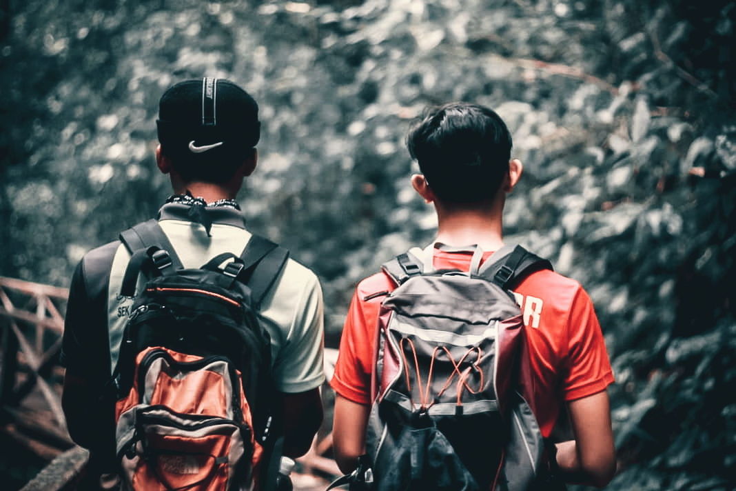 two people, focus on foreground, men, standing, togetherness, people, rear view, real people, clothing, lifestyles, waist up, military, sport, security, boys, day, leisure activity, protection, nature, helmet, uniform, government