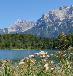Scenic view of mountains and lake against clear sky