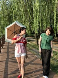 Women walking on footpath