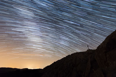 Low angle view of silhouette mountain against sky at night