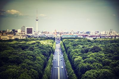 High angle view of road amidst trees in city