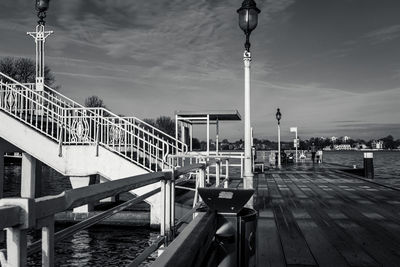Bridge over river in city against sky