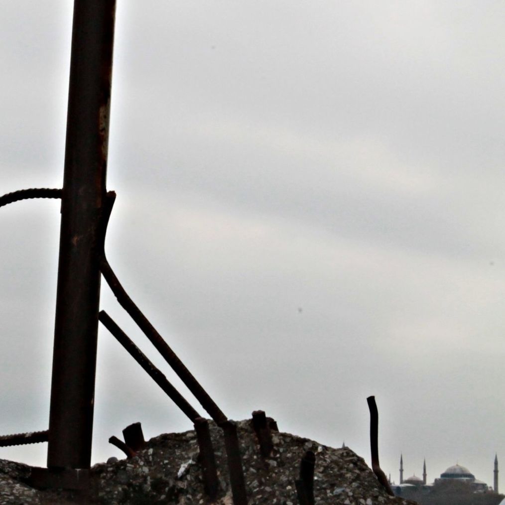 low angle view, sky, day, wood - material, outdoors, weathered, nature, damaged, no people, metal, old, abandoned, rock - object, rusty, clear sky, textured, close-up, deterioration, tranquility, pole