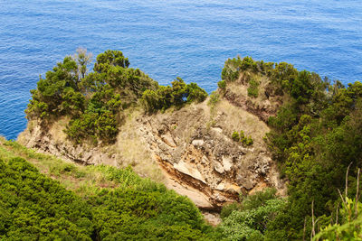 High angle view of rocks by sea