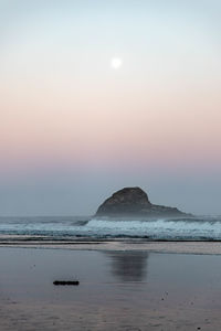 Scenic view of sea against sky at sunset