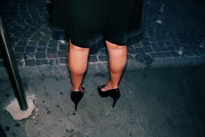 Low section of man with woman standing on street