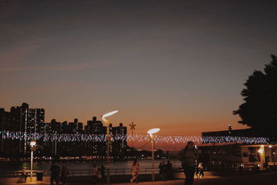 Illuminated buildings against sky at night