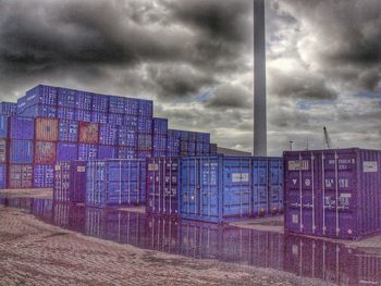 Industrial building against cloudy sky