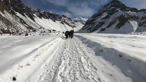 People walking on snow covered mountain