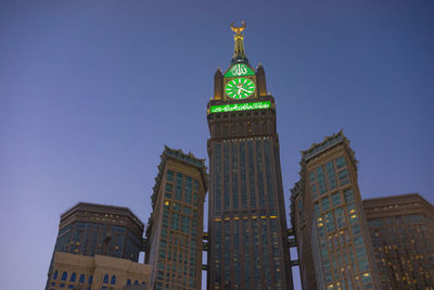 Low angle view of illuminated tower against sky at night