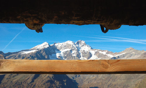 Scenic view of snowcapped mountains against blue sky