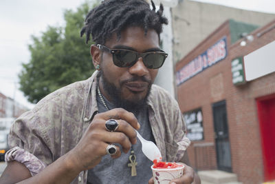 A young man eating frozen yoghurt.