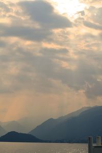 Scenic view of mountains against cloudy sky