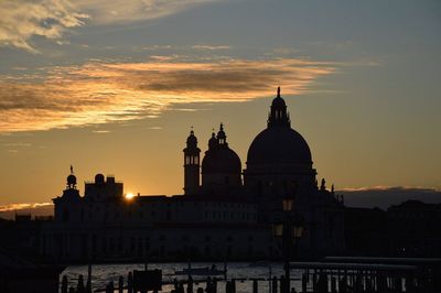 Historical buildings against sky during sunset in city