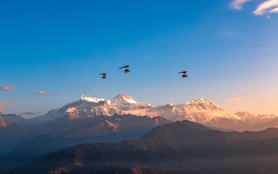 Scenic view of snowcapped mountains against clear blue sky