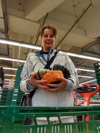 Portrait of a smiling young woman holding food